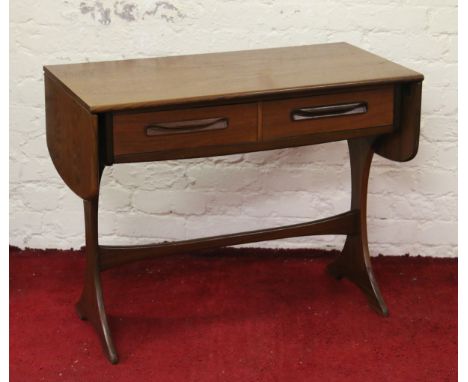 A 1970 teak sofa table raised on splayed supports.