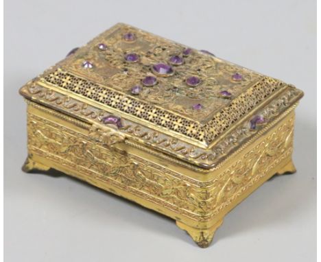 A small gilt metal jewellery casket inlaid with amethyst coloured stones. 