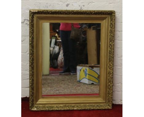 A large gilt framed wall mirror.