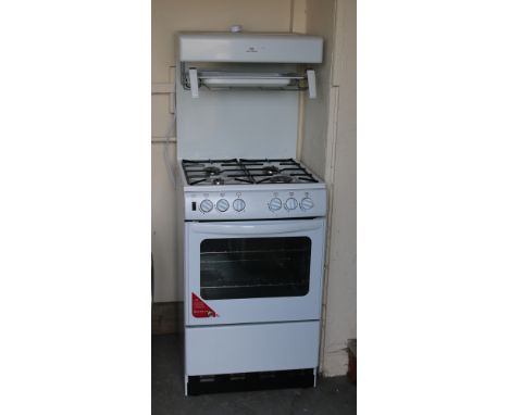A white enamel New World gas cooker.
