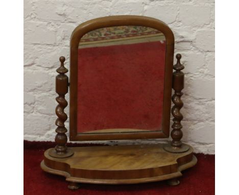 A Victorian walnut toilet mirror with barleytwist supports.
