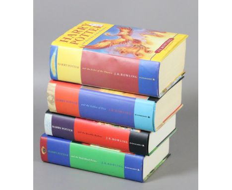 Four First Edition Harry Potter volumes.