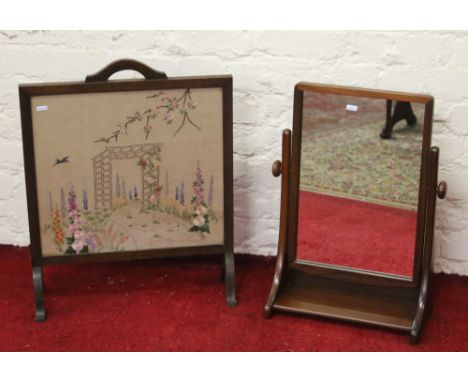 An oak firescreen along with a teak framed bathroom mirror.
