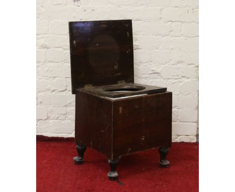 A mahogany cased commode raised on squat cabriole supports.