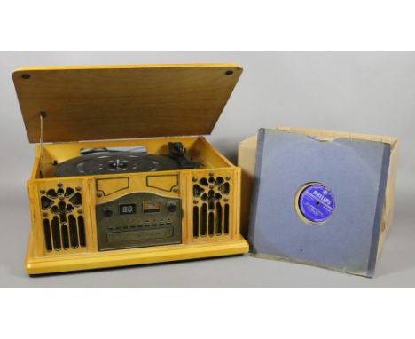 A box of 78 and 45 rpm records along with a retro looking record/cd player.
