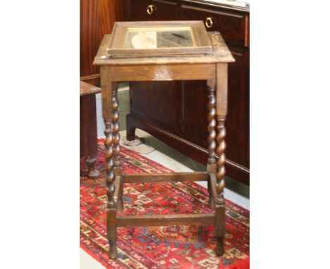 An oak barleytwist occasional table and an oak framed mirror.
