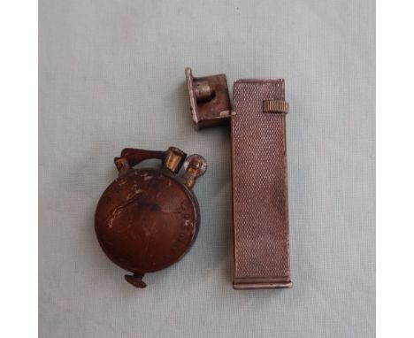 A Dunhill white metal lighter, Cartier Licence, with an engine turned body together with a trench art lighter constructed fro