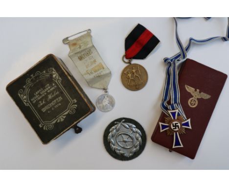 A Third Reich Mothers cross, with blue and white enamel, the reverse inscribed 16 Dezember 1938 together with another German 