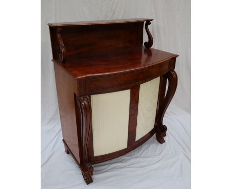 A Victorian mahogany chiffonier, with a raised shelf on scrolling supports, above a bowed top, frieze drawer and two cupboard