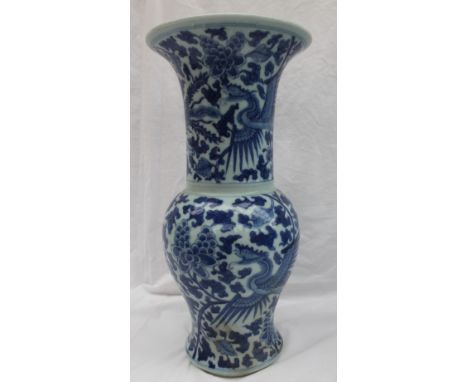 A pair of Chinese blue and white porcelain vases of baluster shape with a flared top, decorated with multiple phoenix in flig