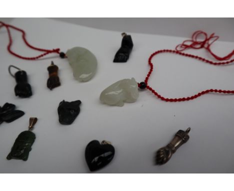 A jade pendant carved as a buffalo, on a red cord, together with another carved as a horse, and various other hardstone carve