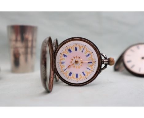 A continental white metal fob watch, the white enamel dial with a gilt highlighted pink enamel centre and blue enamel Roman n