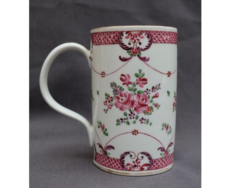 A 19th century Chinese Famille Rose porcelain tankard, decorated with flowers, leaves and swags, 14.5cm high x 9.5cm diameter