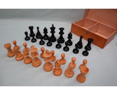 A turned wooden chess set, with weighted pieces, one side ebonised, King 9.5cm high, pawn 4.5cm high 