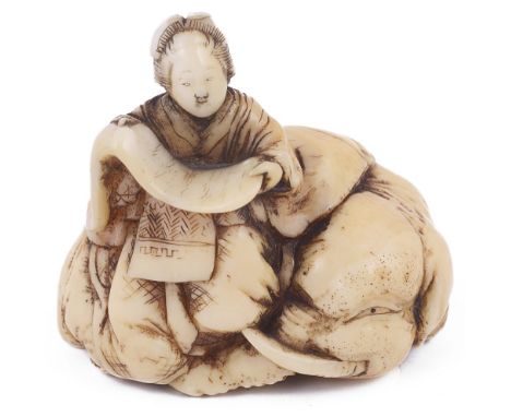 ˜IVORY NETSUKE OF KIMI NO EGUCHI ON A RECUMBENT ELEPHANT, CIRCA 1850 signed: Toun 3.2cm high Provenance: The Netsuke Collecti
