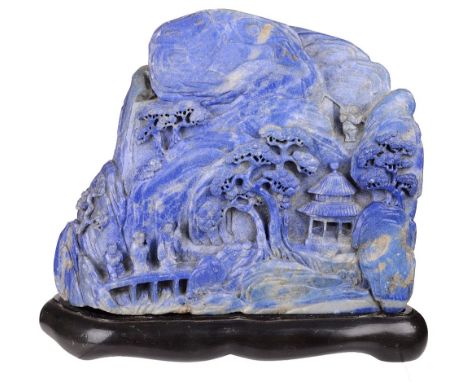 ‡&nbsp;A CHINESE LAPIS LAZULI MOUNTAIN, 19TH CENTURY deeply carved on the front with a sage and two attendants traversing a b