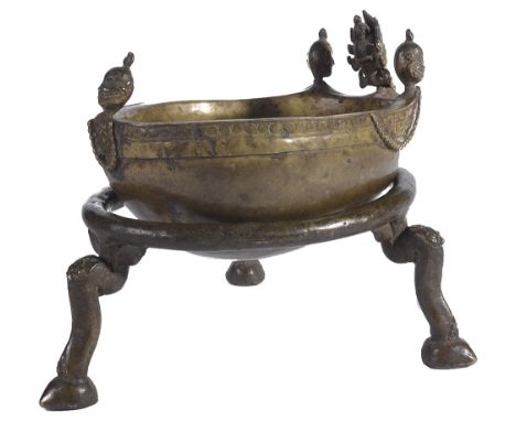 A RITUAL SKULL BOWL, NEPAL, CIRCA 18TH CENTURY mounted in brass, a bodhisattva head and three heads of citipati around the ri