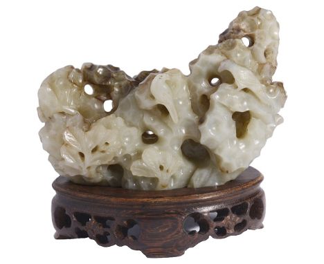 A CHINESE GREY JADE ROCKWORK BRUSH REST carved and pierced as rockwork with a reclining figure and a tiger to the front face,