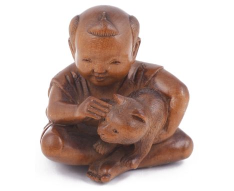 WOOD NETSUKE OF A BOY PETTING A CAT, CIRCA 1870 the cord holes with stained bone rings, signed on a red lacquer tablet: Ryomi