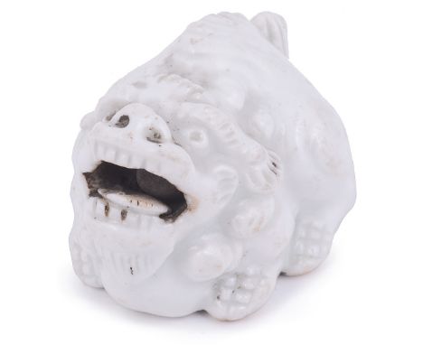 PORCELAIN NETSUKE OF A CROUCHING SHISHI LION, CIRCA 1870 with a loose ball in its mouth, unsigned 4.1cm long Provenance: The 