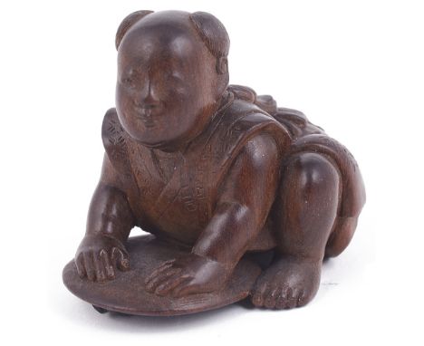 WOOD NETSUKE OF A BOY CRUSHING A FIREFLY WITH A FAN, CIRCA 1870 signed: Gyokkei 2.9cm high Provenance: The Netsuke Collection