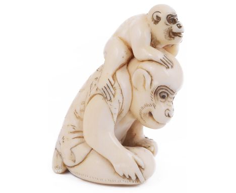 ˜LARGE IVORY NETSUKE OF A MONKEY AND YOUNG, CIRCA 1800 the adult a performing monkey in a jacket, its eyes inlaid with dark h