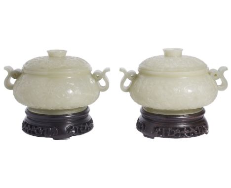 A PAIR OF CHINESE CELADON JADE CENSERS AND COVERS each compressed globular body rising from a short spreading foot to an ever