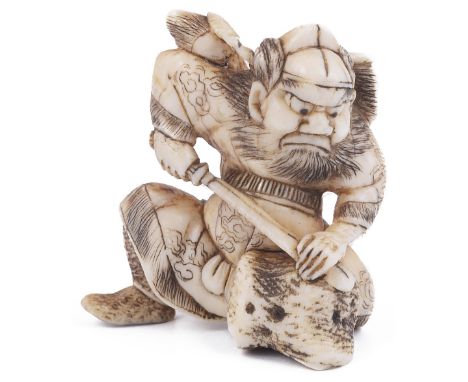 ˜IVORY NETSUKE OF SHOKI THE DEMON QUELLER, CIRCA 1870 sharpening his sword on a rock, extensive incised and stained detail, u