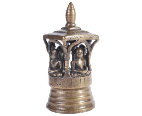 A SMALL JAIN BRASS SHRINE, WESTERN INDIA, CIRCA 17TH CENTURY in the form of a four-sided canopied pavilion, on raised circula