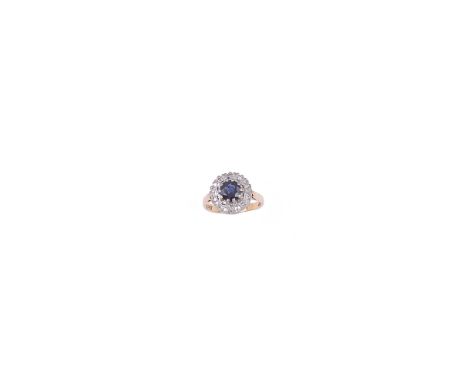 SAPPHIRE AND DIAMOND RING, CIRCA 1979 the circular sapphire within a border of single-cut diamonds, hallmarked London, 1979, 