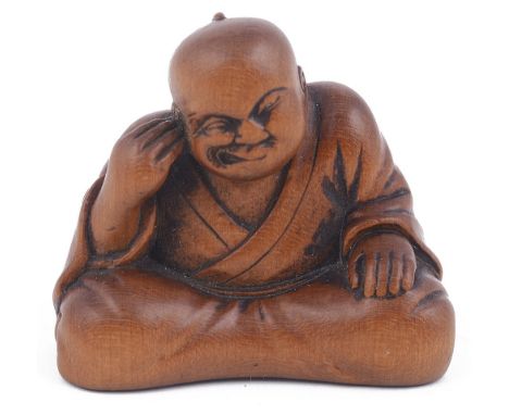 ˜WOOD NETSUKE OF A MAN PICKING HIS EAR, CIRCA 1870 highly expressive and amusing, signed: Ryukosai Jugyoku with seal ju on an