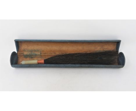 A JADE CYLINDRICAL FITTING plain, mounted as a fly whisk, the horse-hair centred by a peacock feather, in case 6.5cm long Pro