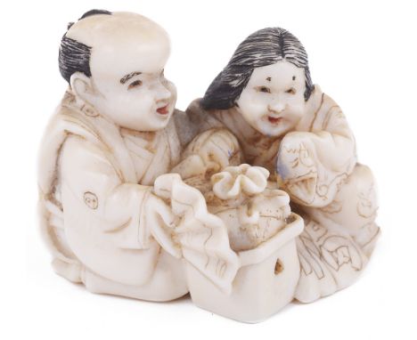 ˜PARTLY STAINED IVORY NETSUKE OF A MAN WITH OKAME, CIRCA 1870 he pointing at a suggestively shaped ginseng root, with erotic 