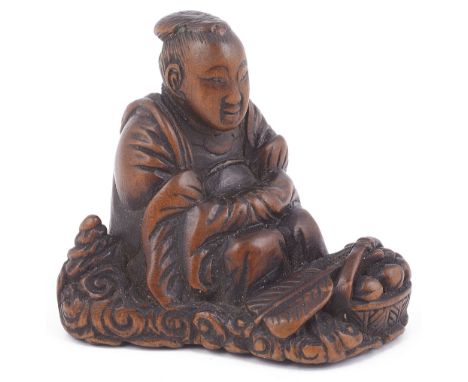 WOOD NETSUKE OF SEIOBO WITH A BASKET OF IMMORTAL PEACHES, CIRCA 1850 seated on a bed of clouds, signature tablet lost 3cm hig