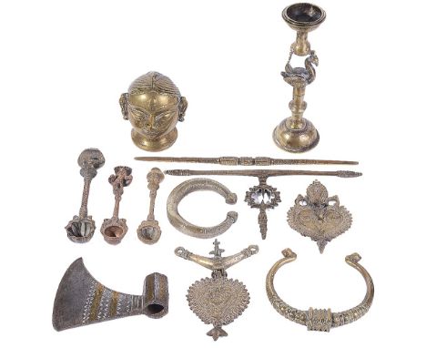 A COLLECTION OF INDIAN METAL OBJECTS, MOSTLY 19TH CENTURY mostly brass, including a Gauri head, three puja spoons, an axe hea