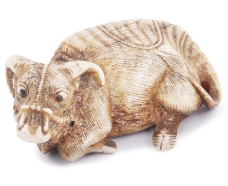 STAG ANTLER NETSUKE OF A RECUMBENT OX, CIRCA 1800 with eyes inlaid in dark horn, signed: Tomomasa 5.5cm long Provenance: The 