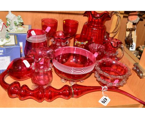 A GROUP OF CRANBERRY COLOURED GLASS ITEMS, to include jugs, bowls, pipe, approximate length 42cm, etc (12)