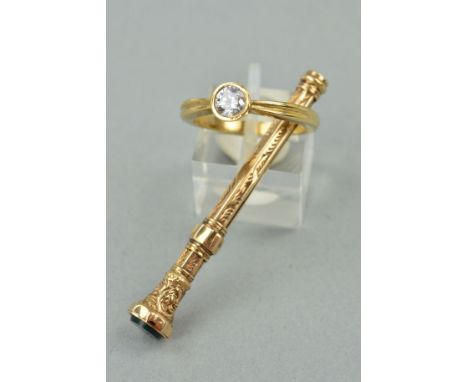 A 9CT GOLD RING AND AN EDWARDIAN RETRACTABLE TOOTHPICK, the ring designed as a circular cubic zirconia within a collet mount 