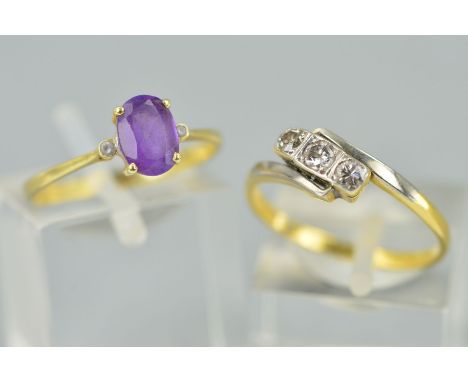 TWO GEM SET RINGS, the first designed as a central oval amethyst flanked by small circular colourless pastes, stamped 585, ri