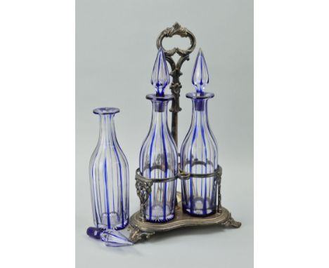 A TREFOIL SILVER PLATED DECANTER STAND with centre carry handle and three blue flashed glass decanters (stoppers chipped)