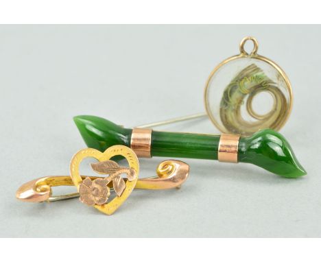 TWO EARLY 20TH CENTURY BROOCHES AND A HAIR PANEL PENDANT, the first brooch designed as an elongated carved jade panel, the se