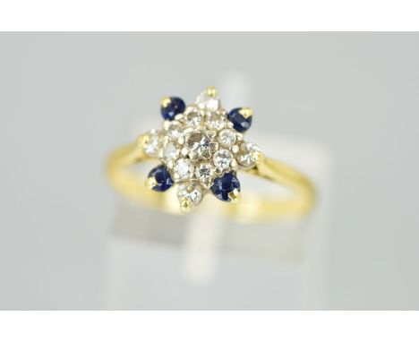 A SAPPHIRE AND DIAMOND DRESS RING, designed as a cluster of brilliant cut diamonds to the four outer circular sapphires, esti