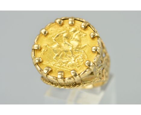 A GOLD HALF SOVEREIGN RING, the half sovereign within a claw setting, to the fancy ring mount with pierced scrolling shoulder