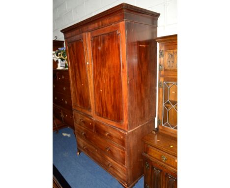 A GEORGIAN WALNUT AND MAHOGANY LINEN PRESS, the double panelled doors revealing four large slides above two short and two lon