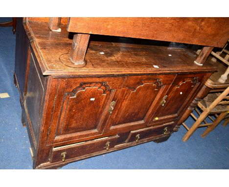 A GEORGIAN OAK PANELLED TWO DOOR CUPBOARD with two drawers, on bracket feet (adapted from a mule chest), approximate width 13