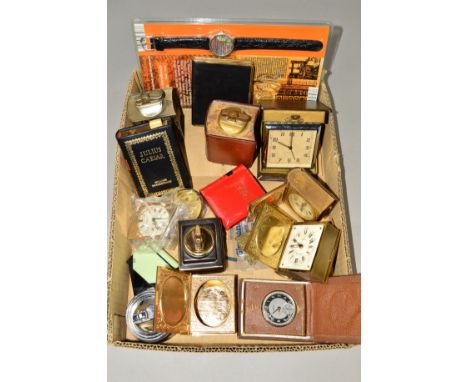 A SMALL BOX OF MISCELLANEOUS ITEMS to include travel clocks, table lighters, a plastic lighter designed as a book, two lighte