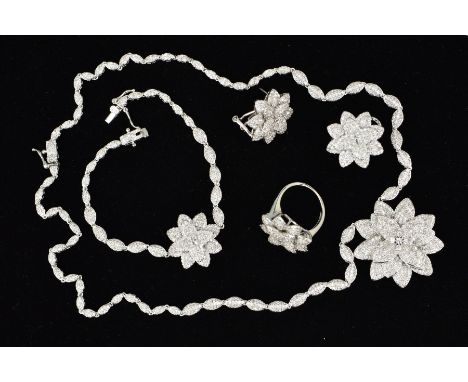 A SUITE OF COSTUME JEWELLERY INCLUDING PENDANT, EARRINGS, RING AND BRACELET