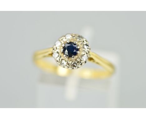 A SAPPHIRE AND DIAMOND CLUSTER RING, the central circular sapphire within a single cut diamond surround, estimated total diam