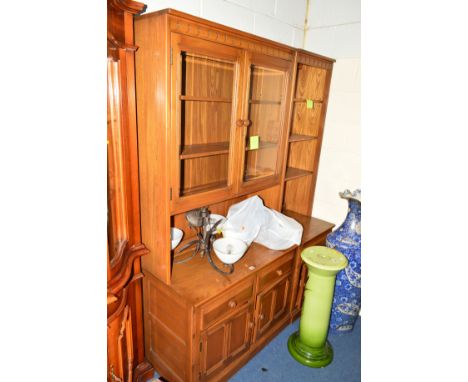 AN ERCOL ASH TWO SECTION WALL UNIT, comprising of a double glazed cupboard, an open section above three drawers and cupboard 