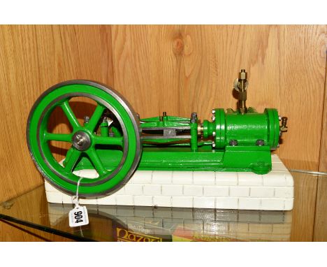 A HORIZONTAL SINGLE CYLINDER LIVE STEAM ENGINE, not tested, mounted on a re-painted brick effect wooden tank, some damage to 